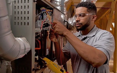 Technician working on HVAC unit